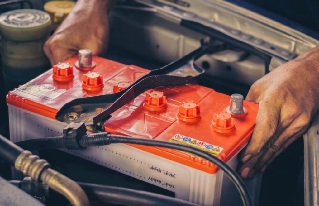 Close up of a Ford Technician replacing a battery.