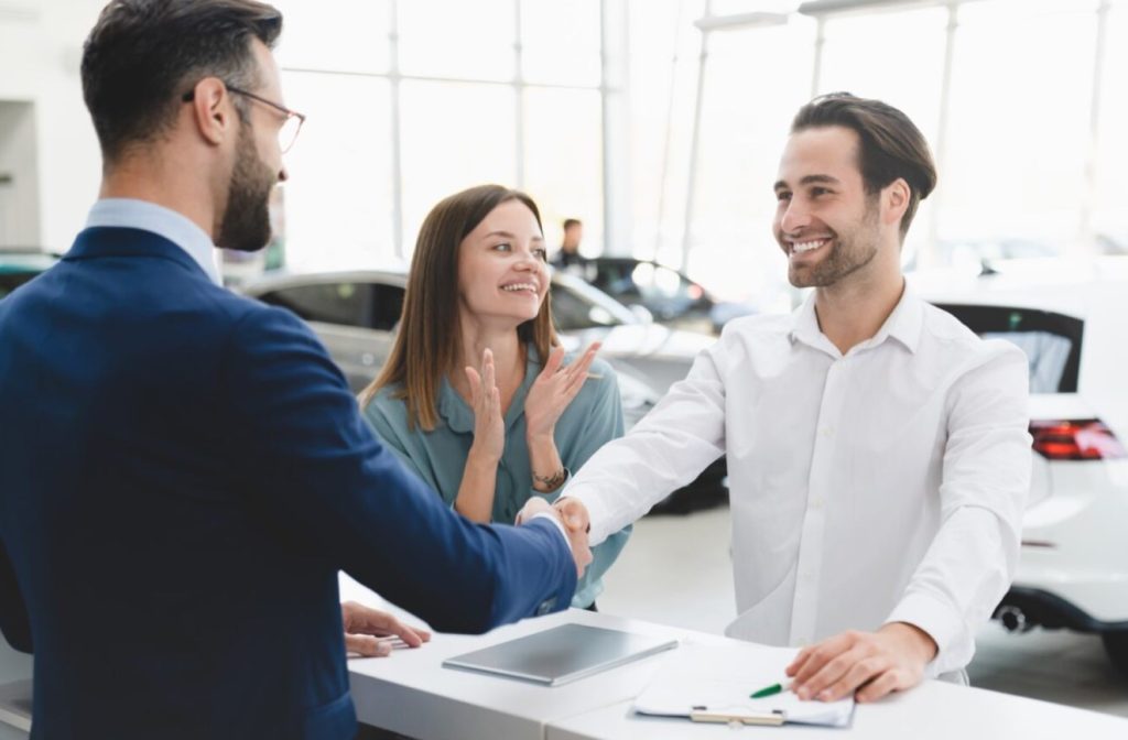 a couple with huge smiles on their faces as they work with Lufkin Fords finance department securing a new Ford!